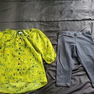 girl med capri leggings and bright splatter design top